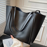 Fashionable black handbag - large capacity, lightweight and easy to carry.