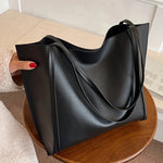 Fashionable black handbag - large capacity, lightweight and easy to carry.