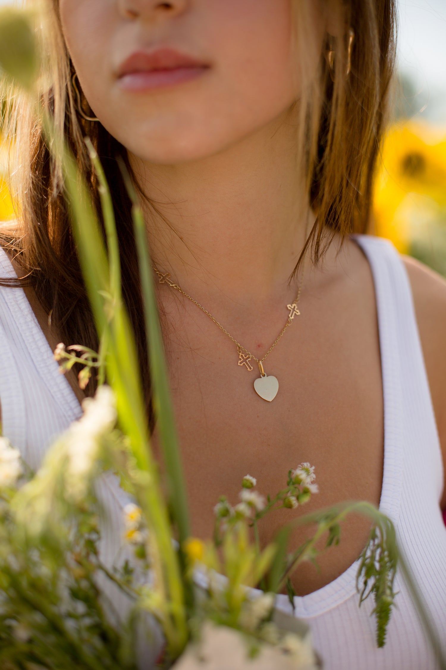 files/close-up-of-a-gold-necklace-on-a-person-in-a-white-shirt.jpg
